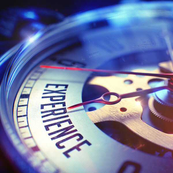 Vintage pocket watch face with the text "Experience" close up.