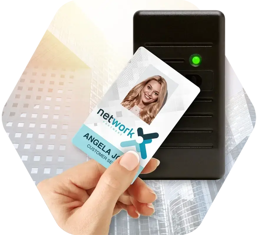A hand holds a corporate ID card up to a card reader