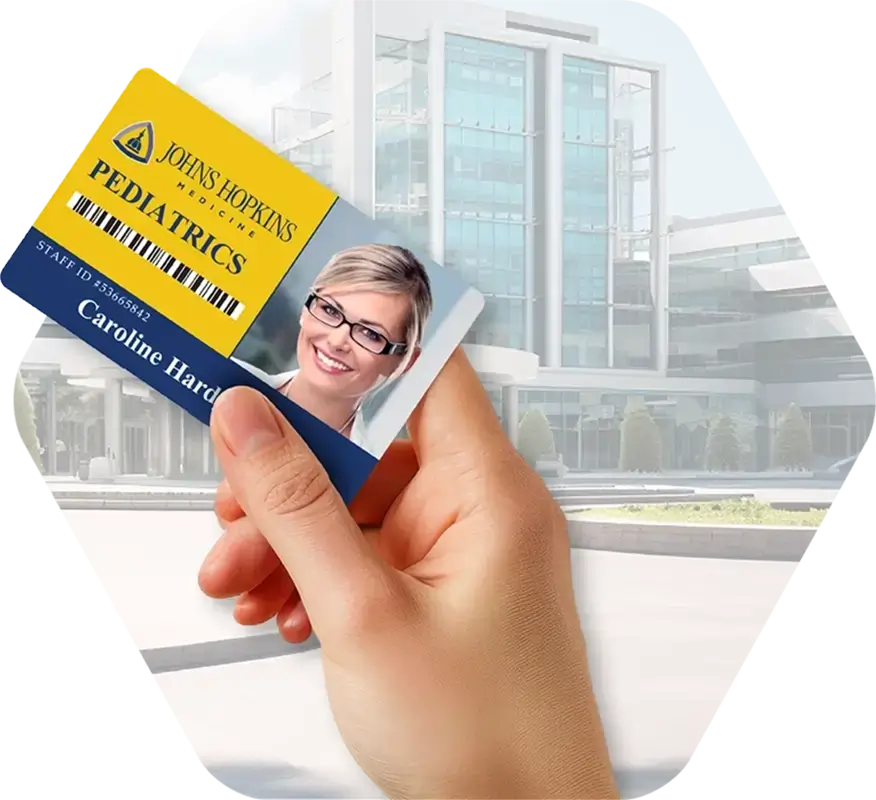 A hand holds a healthcare / hospital employee ID card