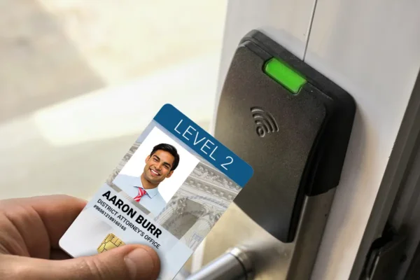 A low freccess card being held up to an RFID PACS reader