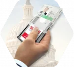 A hand slides open a shielded card holder covering a government ID