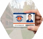 A hand holds a higher education / college student ID card